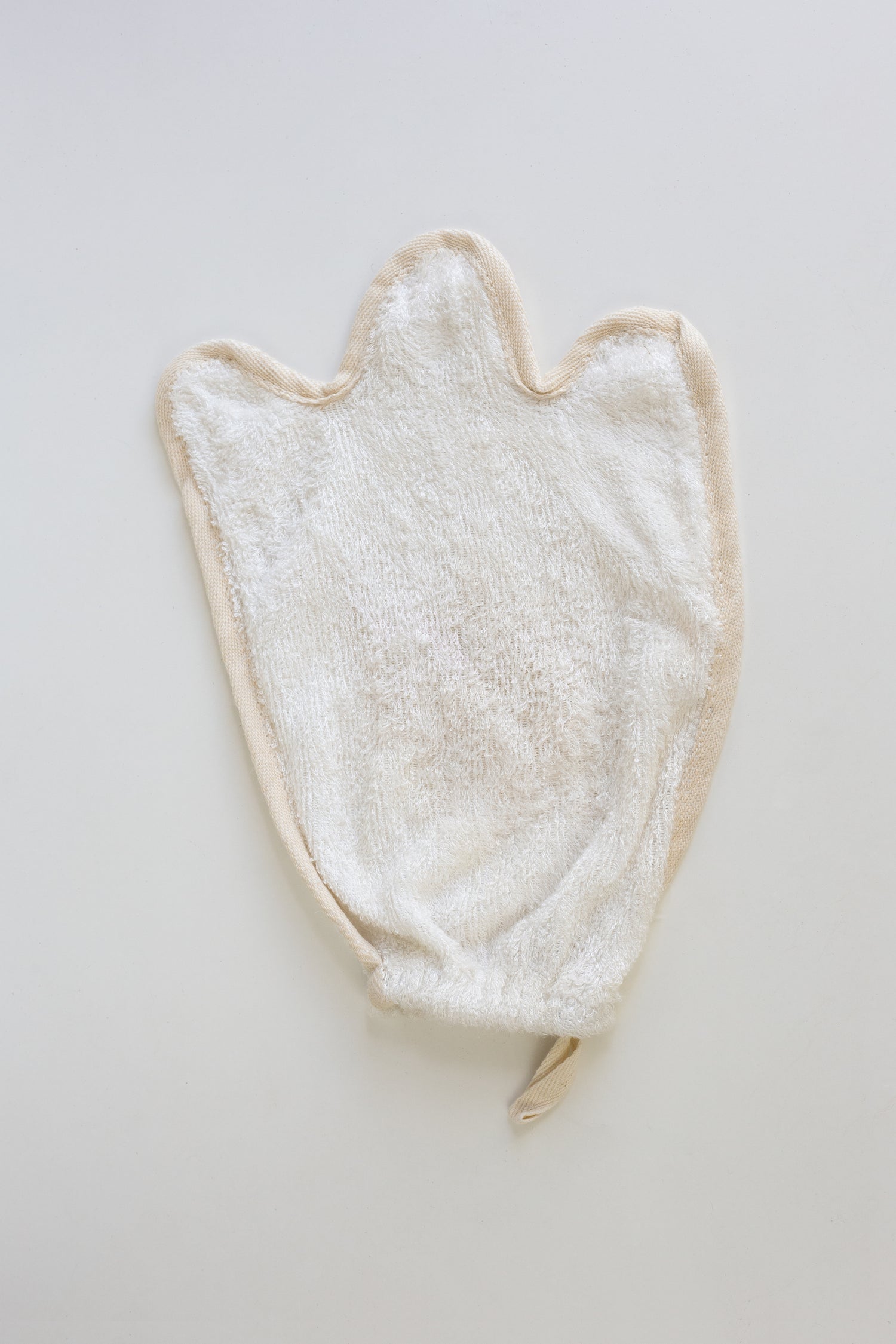 White towel/Mitt/flannal with a ghost shape on a light gray background