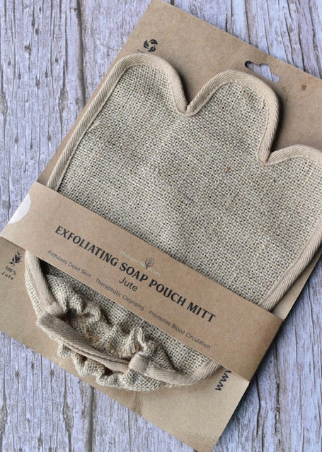 Exfoliating soap pouch mitt on a cardboard packaging with text on a wooden surface