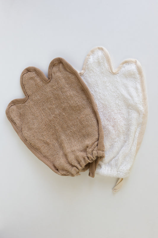 Two natural mitts, one brown and one white, on a light gray backgroud. Bamboo and jute mitt combo