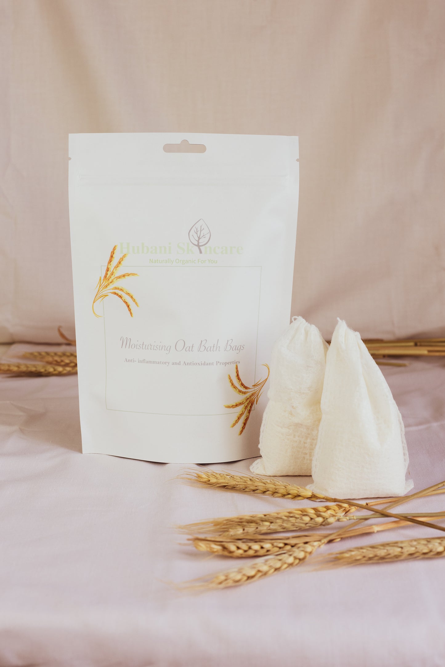 White product packaging with gold accents on a pink background with wheat stalks.